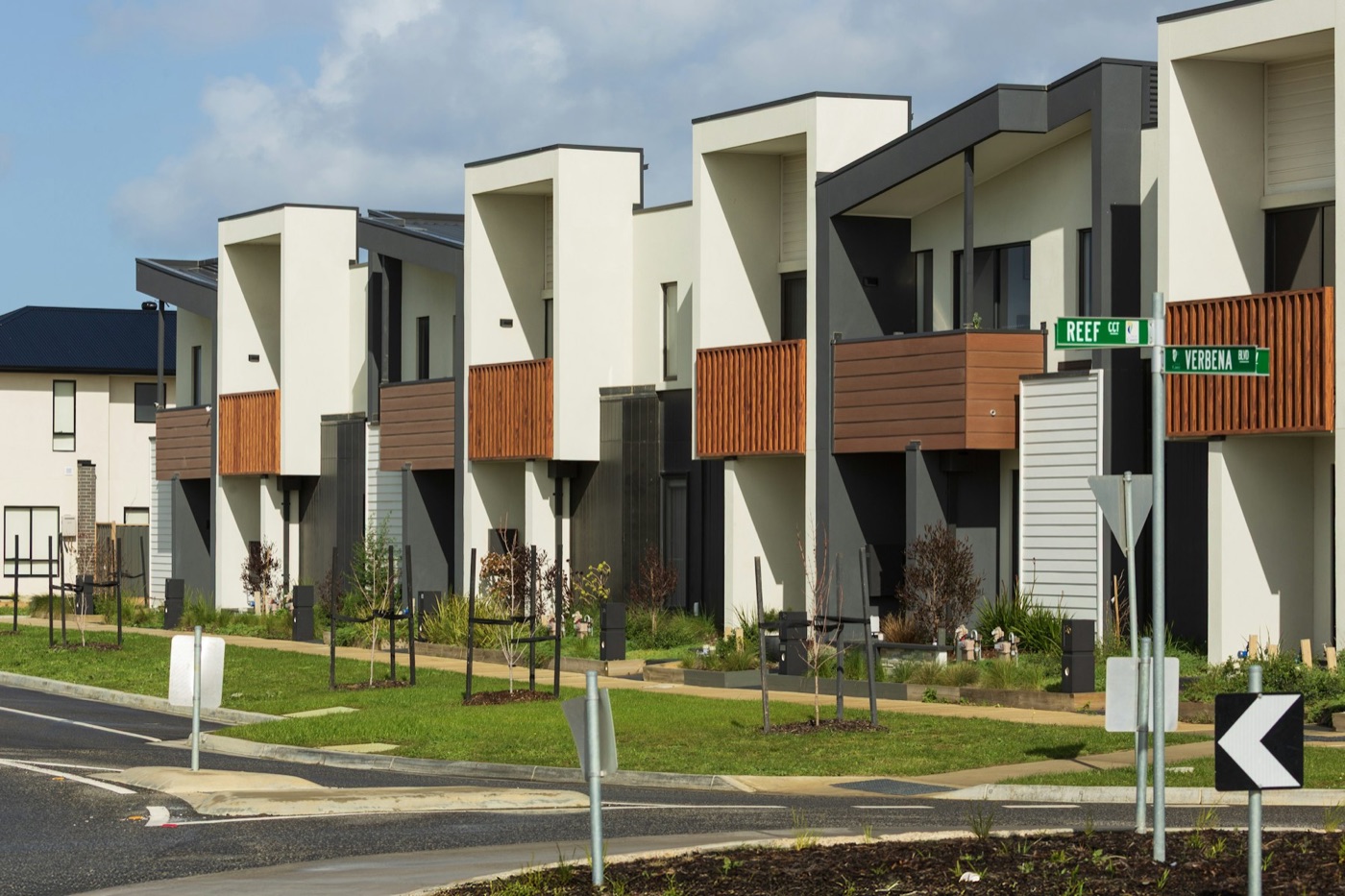 Row of new dual-occupancy townhouses with timber battens